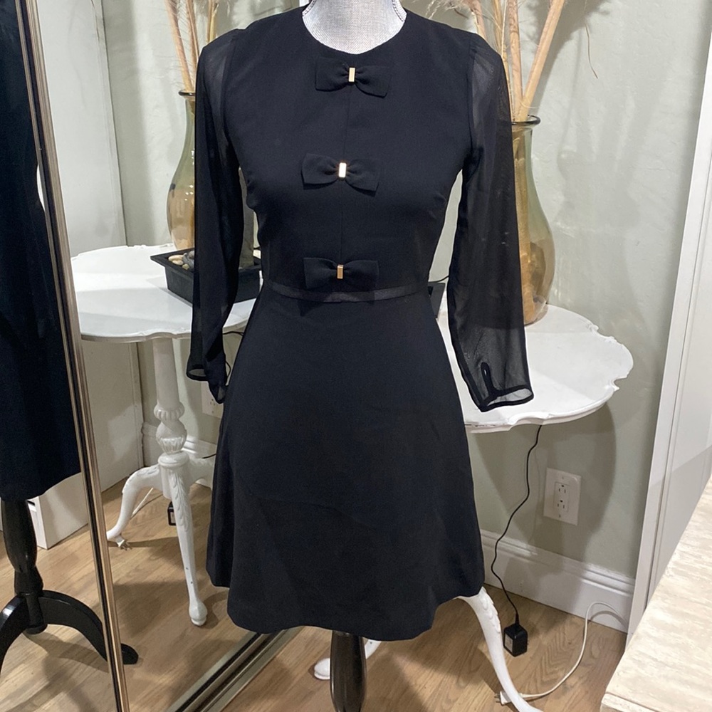 Black dress with bows and sheer sleeve